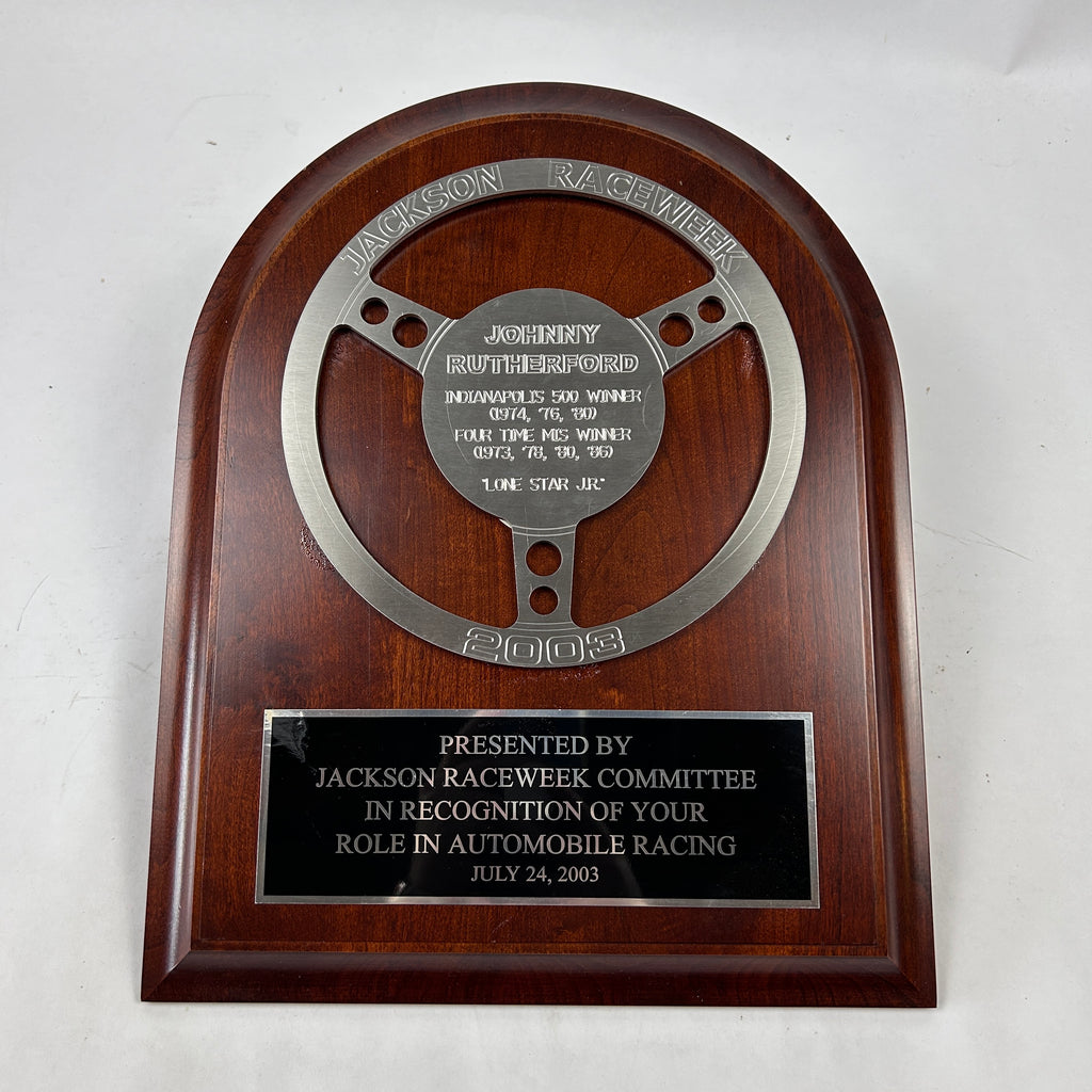 Johnny Rutherford's 2003 Jackson Raceweek Award Plaque. Indianapolis 500 Winner 1974, 1976, 1980. Michigan International Speedway 1973, 1978, 1980, 1986. Presented by Jackson Raceweek Committee.