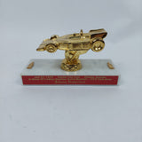 Johnny Rutherford's in honor of Lindsey Hopkins Grand Marshal Trophy Award. Presented by the Capital City Club in 1978 .