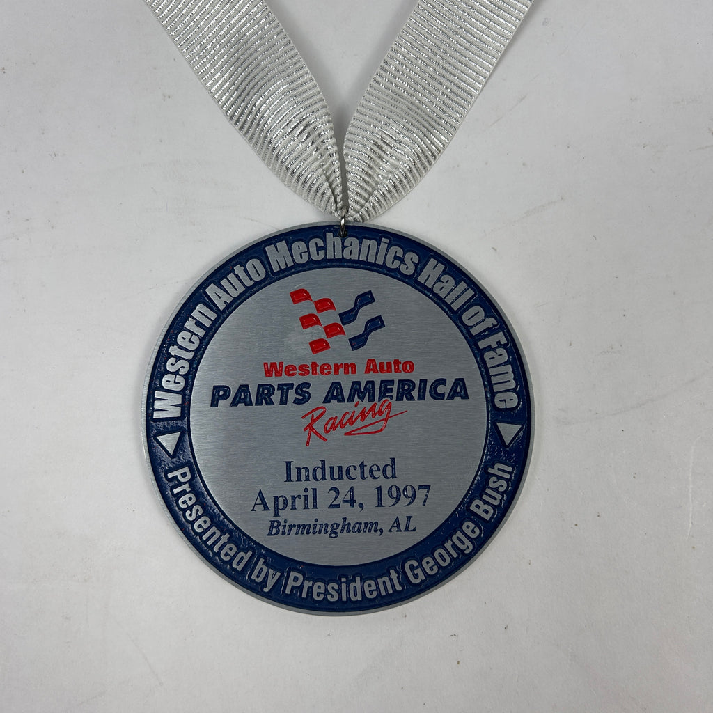Johnny Rutherford's Western Auto Mechanics Hall of Fame Induction Medallion. Presented by President George Bush in 1997.