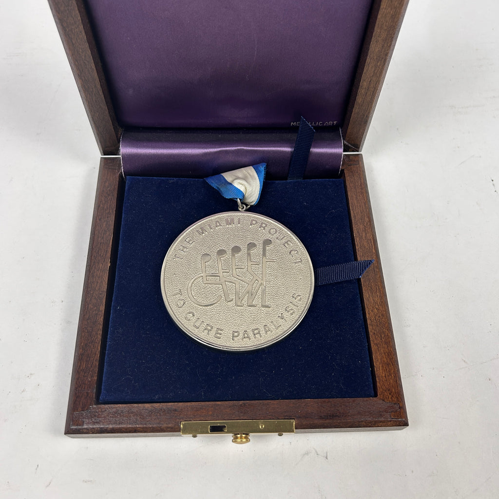 Johnny Rutherford's 1995 Great Sports Legend Dinner The Miami Project Medallion.